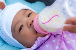 Infant Drinking Formula From Bottle