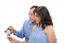 Couple Looking At Ultrasound Photos