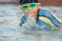 Swimming in wading pool in backyard